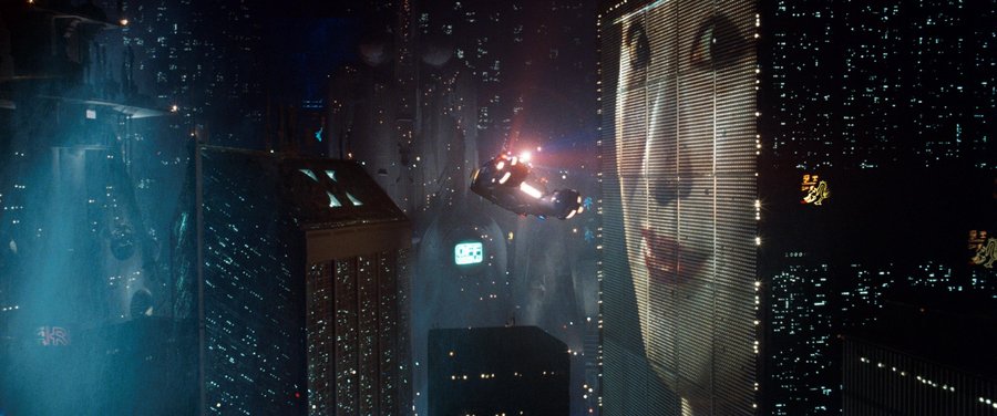 A police spinner flying through the neon-lit night cityscape of Blade Runner